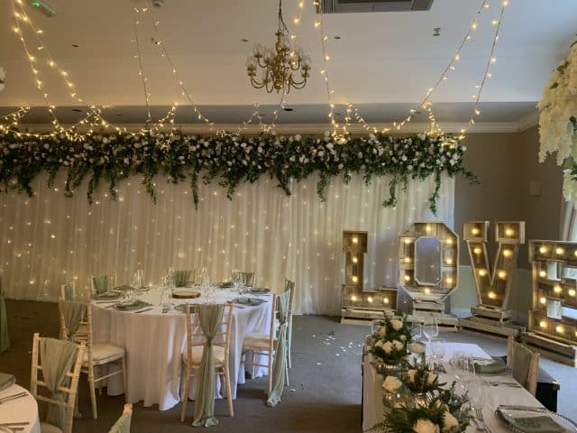 Hollins Hall - Starlight Backdrop - Green & White Floral Topper - With Fairy Light Ceiling